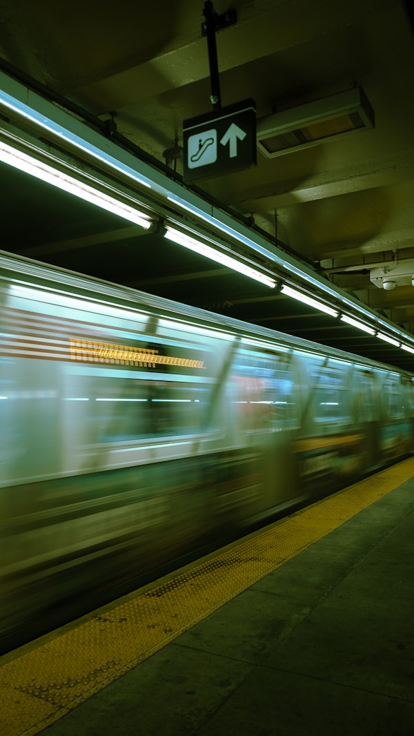 a blurry photo of a subway train passing by